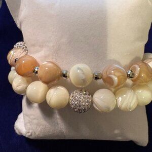 bracelet set has a soft, elegant, and neutral aesthetic with a polished, modern